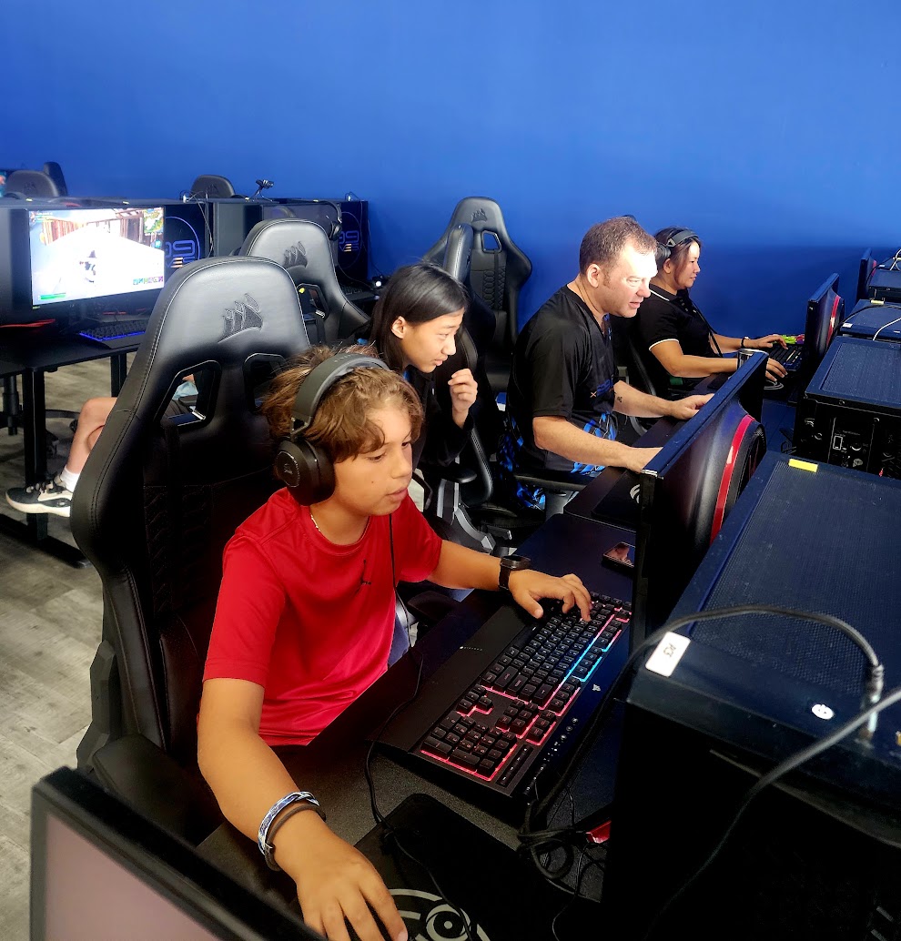 Students creating at x99Lives with a mentor at the computer